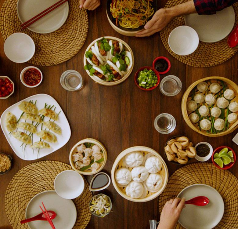 A family at the dinner table having a chinese feast